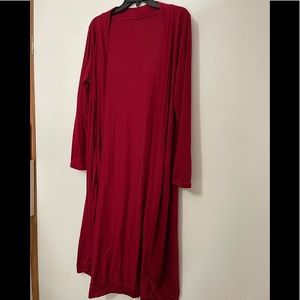 Burgundy, rounded hem kimono type duster.  Banded cuff and banded at the bottom